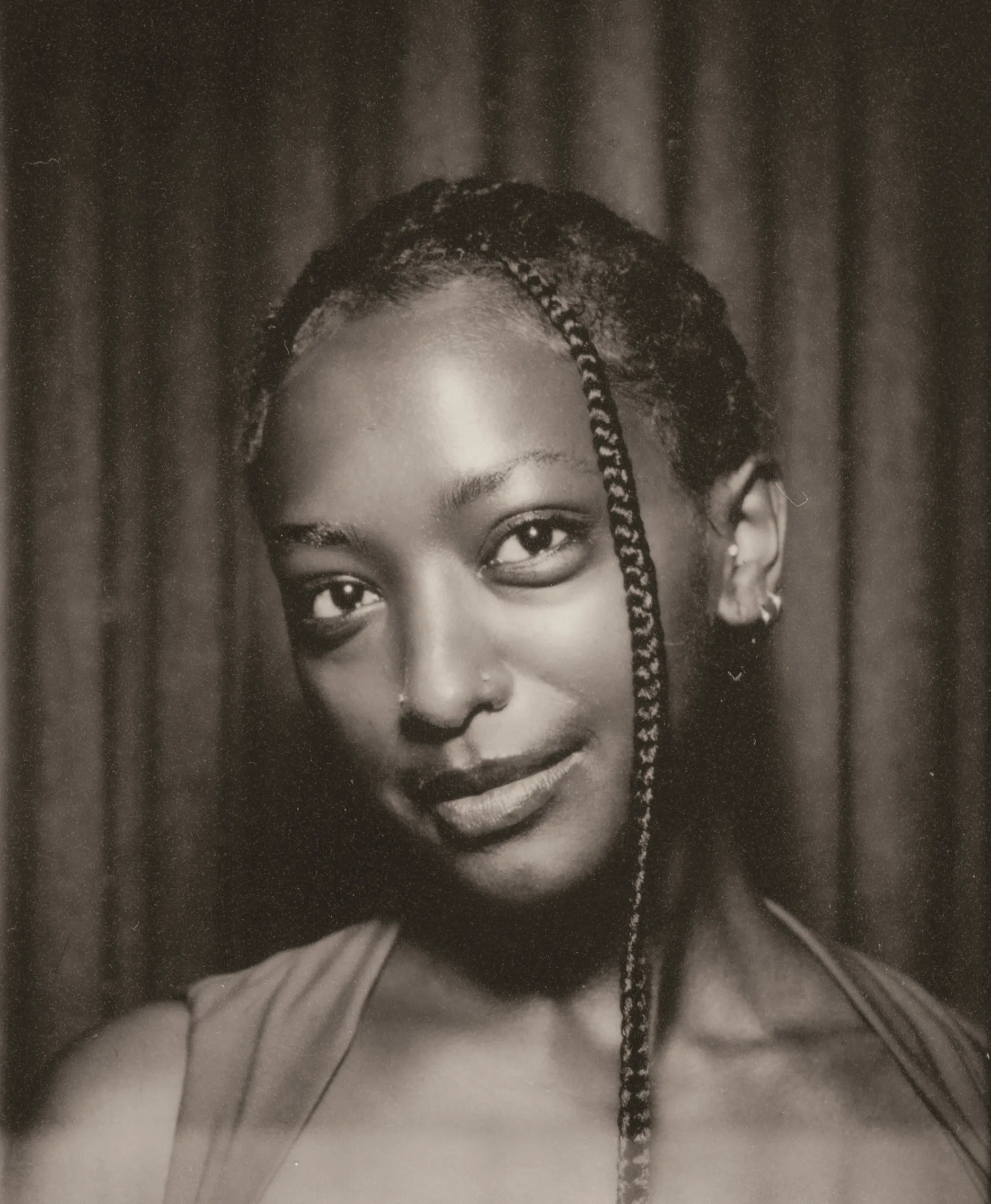 Film photo booth strip frame two: a soft smile in front of the booth curtain